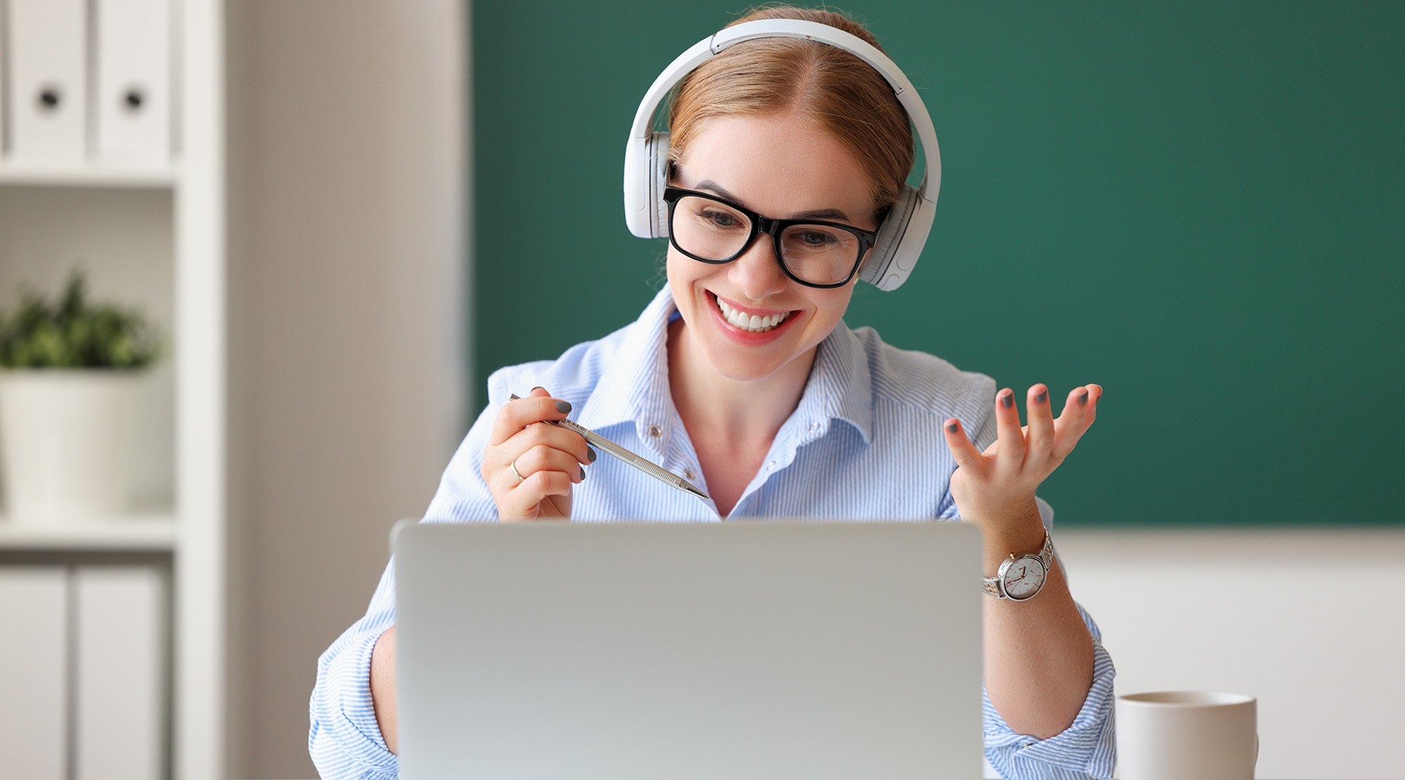 online tutor with headphones on laptop